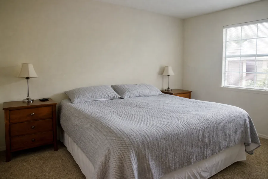 Bedroom with plain off-white walls before wallpaper