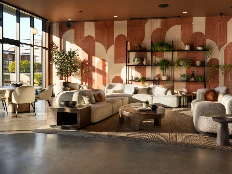 Apartment amenity lounge with terracotta arc mural wall